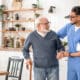 medical-worker-helping-his-patient-to-move-around-the-apartment
