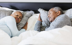 Senior African-American couple sleeping